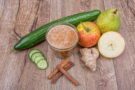 Blended fruit smoothie with ingredients on wooden table