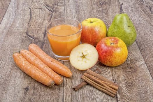 Blended fruit smoothie with ingredients on wooden table