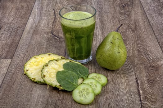 Blended fruit smoothie with ingredients on wooden table