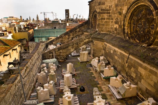 Church in restoration with stone pieces over the roof at Holy Cross and Saint Eulalia, Barcelona, Spain