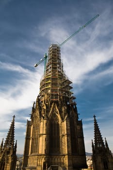 Church in restoration with crane over the elfry at Holy Cross and Saint Eulalia, Barcelona, Spain