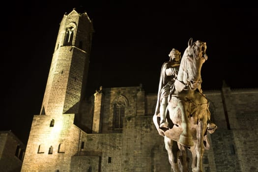 King Ramon Berenguer III statue and the medieval city walls and Santa Agata Chapel with its bell tower
