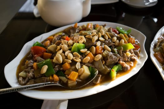 Chinese food - stir fry beef with vegetables and nuts.