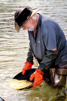 Gold digger in France in the region of Cevennes and the department of Gard in the middle of the river called Le Gardon