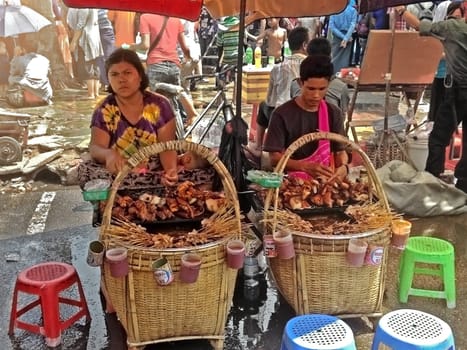Yangon, Myanmar - Apr 15, 2013. Street food sellers in Yangon, Myanmar. Locals eat pot street food.