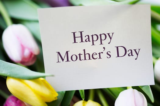 Tulips and card with Happy Mother's day on it.