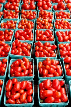 Fresh organic cherry tomatoes background, photo taken at local farmers market, in New York City.