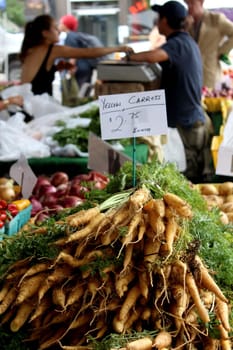 Fresh organic yellow carrots background, photo taken at local farmers market, in New York City