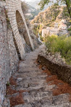 ancient staircase that leads to an isolated church on the hill