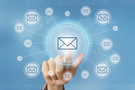 business hand pushing e-mail button with global networking concept