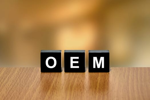 OEM or Original Equipment Manufacturer on black block with blurred background