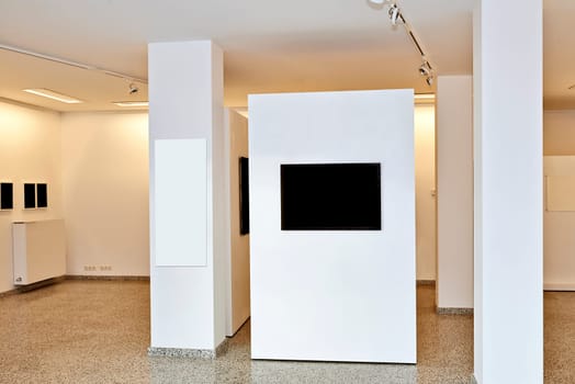 exhibition gallery, wall mounted art with museum style lighting, the art has been removed and replaced. There are path for the frame