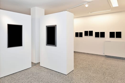 exhibition gallery, wall mounted art with museum style lighting, the art has been removed and replaced. There are path for the frame