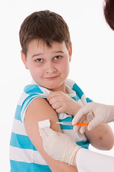 Doctor giving a child injection in arm on isolated image.