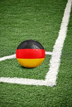 traditional soccer ball on corner from a green soccer field - flag Germany