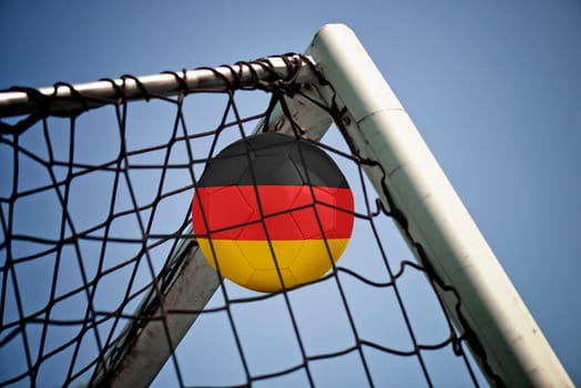 Soccerball in net with the flag of Germany ready for championship