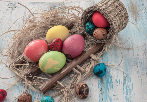 Happy Easter multi-colored eggs on wooden bacground.Easter concept
