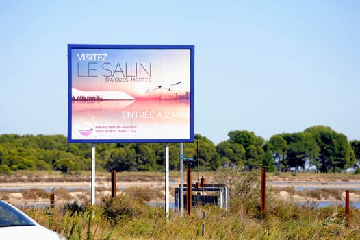 billboard saline Aigues-Mortes in Camargue to announce that tourists can visit the industrial enterprise.