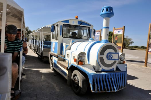 tourists in the tourist train to visit the salt business of Aigues-Mortes and to tour the mine salt site.