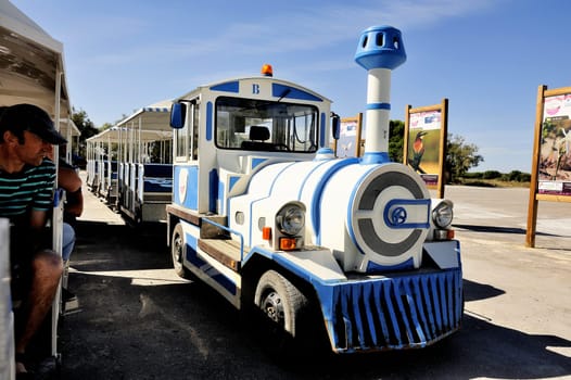 tourists in the tourist train to visit the salt business of Aigues-Mortes and to tour the mine salt site.