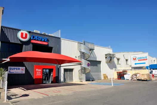 Drive to French supermarket delivery point to pick orders placed with Internet