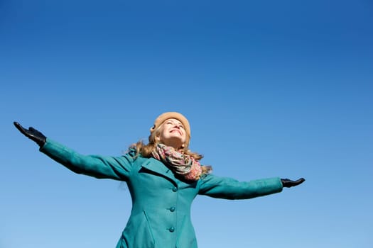 blond casual woman happy outdoors with blue sky