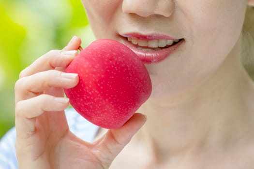 close up women eating red apple