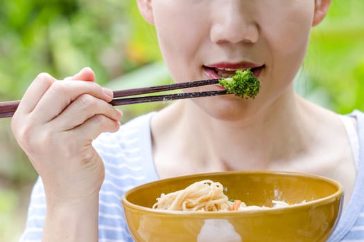 woman hand holding a bowl of noodles