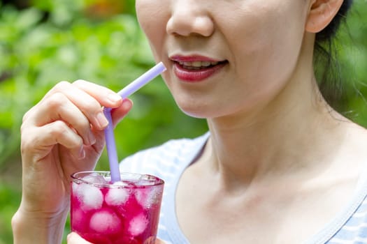 women drinking red grape  juice