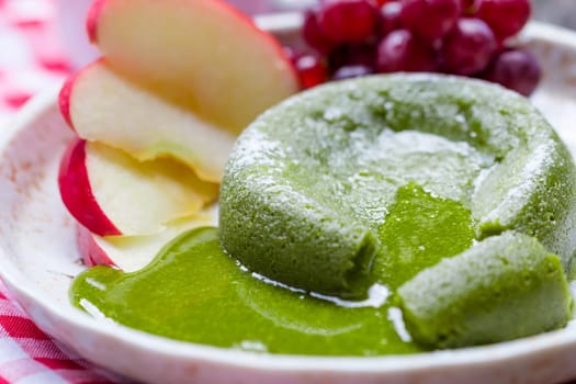Green tea cake in plate on wooden
