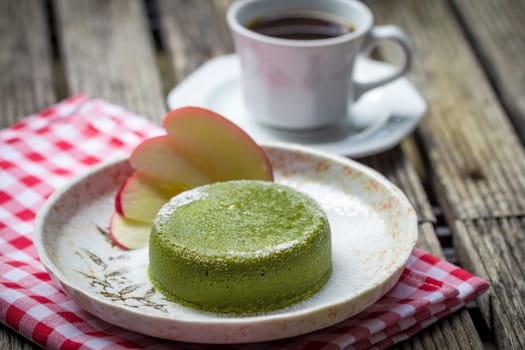 Green tea cake in plate on wooden