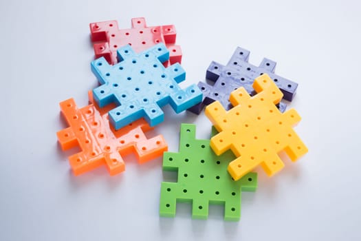 Colorful plastic jigsaw puzzle game, stock photo