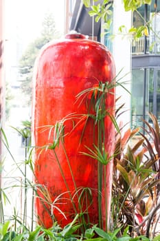 Jar of water springing in garden, stock photo