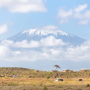 Mount Kilimanjaro, Tanzania., the highest mountain in Africa. Traditional african savannah village in foreground.