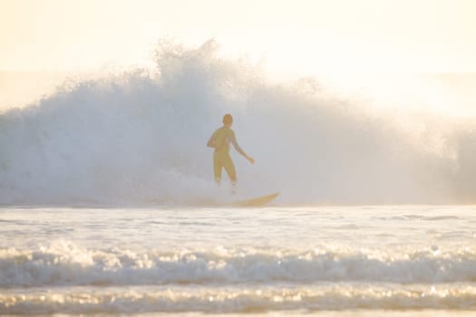 Surfer riding a powerful wave. Panoramic composition.