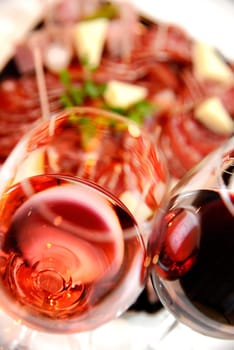 Red and Pink glass of wine with delicatessen