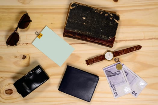 Travel items arranged on a wooden floor. Lay flat Concept