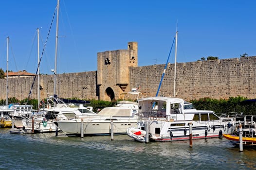 The marina of Aigues-Mortes in the background with the ramparts of the city.