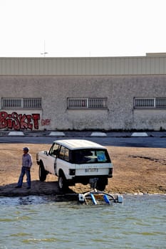 In anticipation of the return of a boat on the Canal du Rhone in Aigues-Mortes in the heart of the Camargue in the south-east of France.