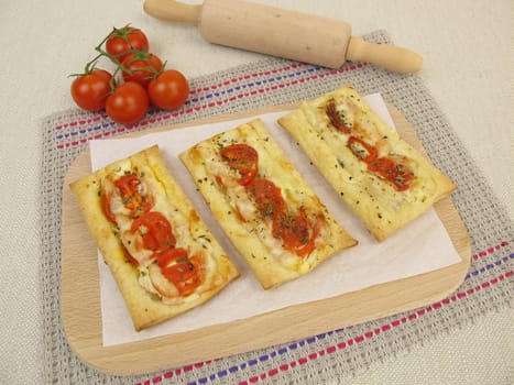 Puff pastry pizza with tomatoes and cheese