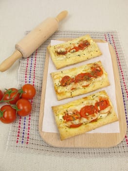 Puff pastry pizza with tomatoes and cheese
