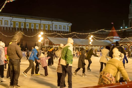 Moscow, Russia - January 05, 2016: People skate on GUM skating rink on Red Square at night