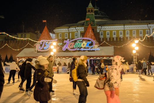 Moscow, Russia - January 05, 2016: People skate on GUM skating rink on Red Square at night