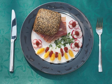 Serano ham rolls with egg and radishes