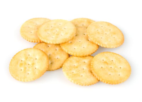 Golden round crackers over white background