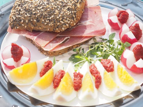 Serano ham rolls with egg and radishes