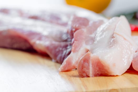 streaky pork with knife on wooden boards