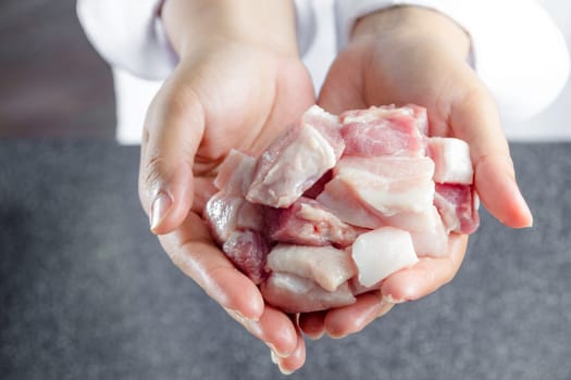 close up chef holding streaky pork