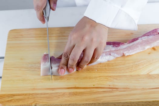 chef sliced streaky pork on cutting boards