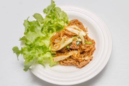 chef making fried noodle in white plate